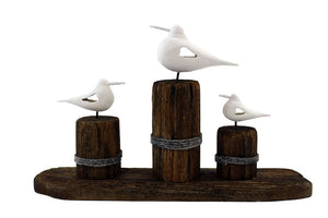 THREE SEAGULLS ON WOOD POSTS